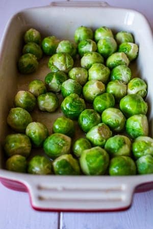 Crispy Roasted Brussels Sprouts Recipe Step 1 brussells sprouts in ceramic pan