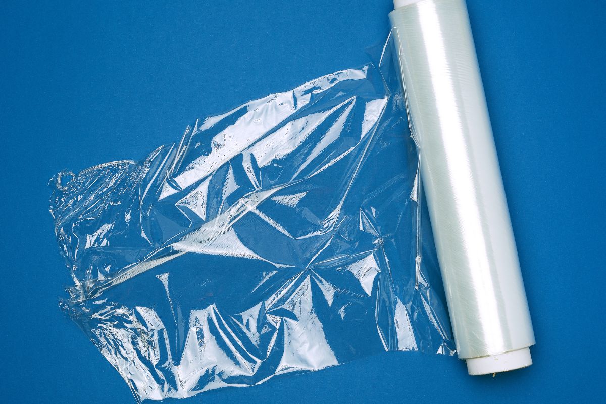 salan wrap 3 Does Saran Wrap Melt? It is unlikely that Saran wrap won’t melt if used in an oven without an aluminum foil layer to protect it. Saran wrap is thinner than a plastic bag and generally cannot handle the high temperatures of a conventional oven. Most polyethylene wraps start to melt at 220°F and we usually cook food at higher temperatures of around 300-400°F. Even hot food out of the oven can cause Saran wrap to melt when it comes into contact with it. Hazards Even before plastic wrap has reached its melting point, toxins can seep into the food it’s wrapped around, according to Environmental Health News. They also state that the FDA has ignored some of the effects caused by a low dose of endocrine-disrupting chemicals. This refers to substances that interfere with the body’s hormone system. Some scientists even question BPA-free wraps and plastic wraps that are marketed as “food-safe”. There is also the question of non-intentionally added substances that are present in Saran wrap that are outside of the manufacturer’s control. These substances could be side products, contaminants, break down products, or a combination of these. These are all points you should consider before deciding to use Saran wrap in the oven. Overall, it is probably better if you don’t use Saran wrap when cooking at all due to the many chemical risks involved. However, if you do wish to use it, be sure to cover the plastic wrap with aluminum foil and cook at a low to moderate temperature. Safer Alternatives To avoid any of the risks associated with using Saran wrap in the oven, there are other, safer alternatives you can use. Instead of using Saran wrap, you can opt to use an oven bag instead, which is completely safe to use and designed for oven cooking. They are heat-resistant and made from grease-proof paper or nylon bags to lock in moisture, leaving your food tender and juicy. These flexible bags give you the same results as using Saran wrap with aluminum foil would. Oven bags can be bought at your local grocery store or online. They are both durable and strong, as well as budget-friendly. They are also very easy to use - all you have to do is put your meat, vegetables, spices, and sauces in the bag and place it in the oven. They can even be used in the microwave. Oven bags also feature detailed usage instructions on their packaging, so you’ll be able to get it right every time. There are also online recipes specifically for oven bags, so you’ll be able to cook whatever you want. Unfortunately, they are single-use, but this is the same for plastic wrap and aluminum foil, so an oven bag is definitely a better option if using Saran wrap makes you concerned. Oven bags are definitely a great alternative that is stress-free, toxin-free, and gives you a tasty meal every time when you refer to the instructions on the packaging.